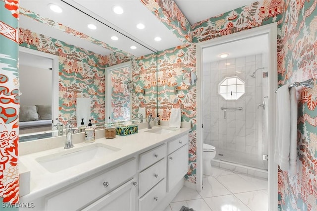 bathroom featuring vanity, toilet, and a shower with shower door