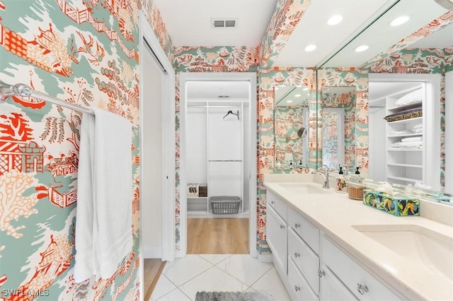 bathroom featuring a shower, vanity, and tile patterned floors