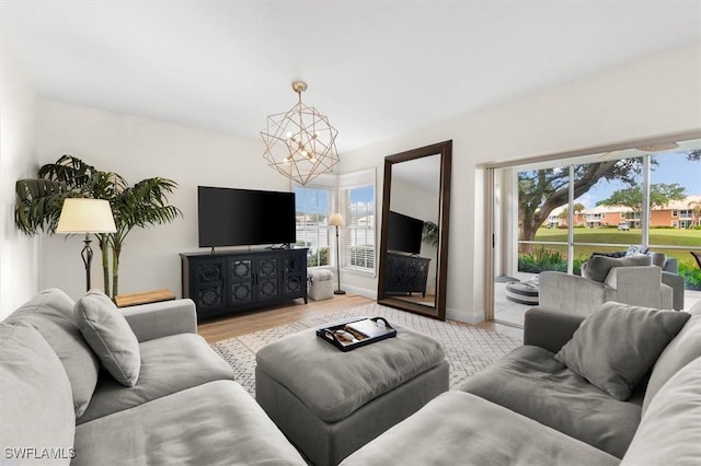 living room featuring light hardwood / wood-style floors and a chandelier