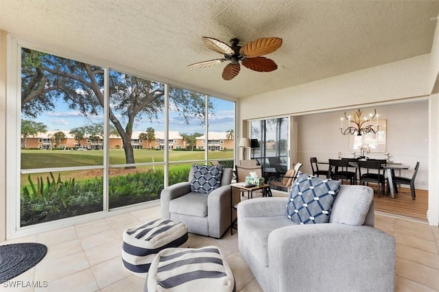 sunroom with ceiling fan with notable chandelier