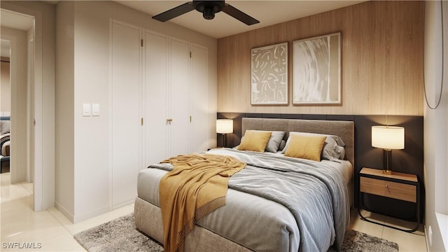 bedroom with light tile patterned flooring, ceiling fan, and a closet