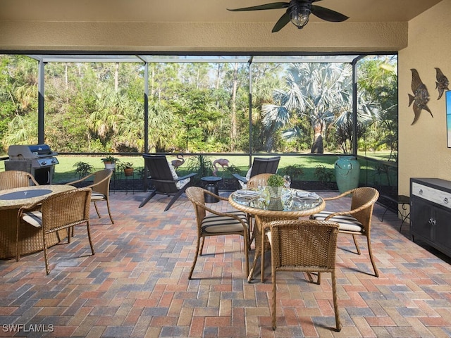 sunroom / solarium featuring ceiling fan