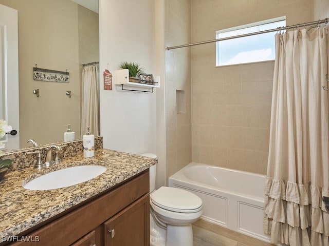 full bathroom featuring shower / bath combo, vanity, and toilet