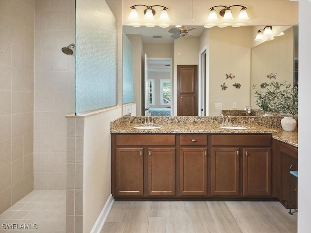 bathroom with vanity, ceiling fan, wood-type flooring, and walk in shower