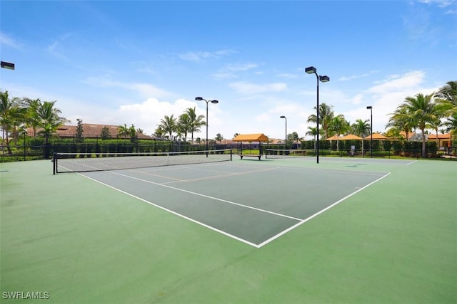 view of tennis court featuring basketball hoop