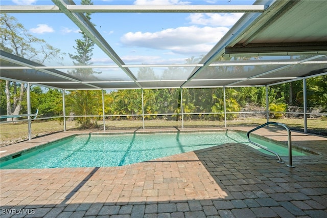 view of swimming pool featuring a patio and glass enclosure