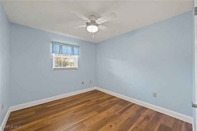 empty room featuring a textured ceiling, hardwood / wood-style flooring, and ceiling fan