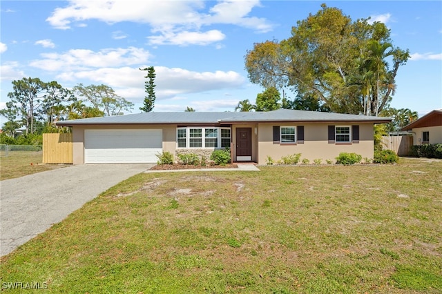 ranch-style house with stucco siding, an attached garage, fence, driveway, and a front lawn