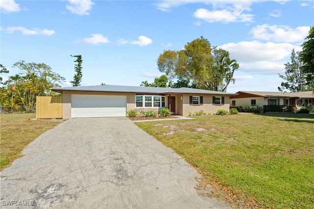 ranch-style home featuring a front lawn and a garage