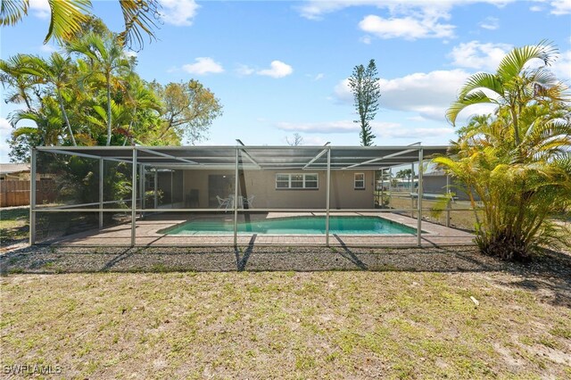 view of pool with glass enclosure