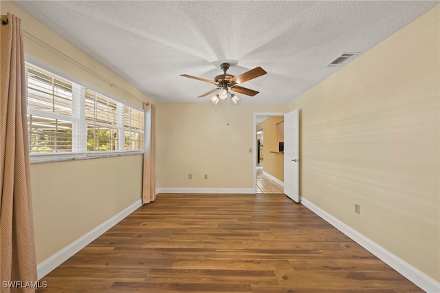 empty room with wood-type flooring, a textured ceiling, and ceiling fan