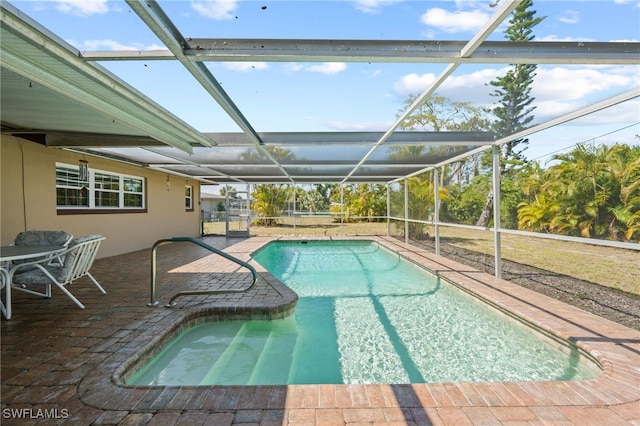 view of swimming pool with a lanai and a patio area