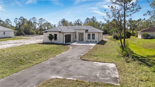 view of front of home with a garage and a front lawn