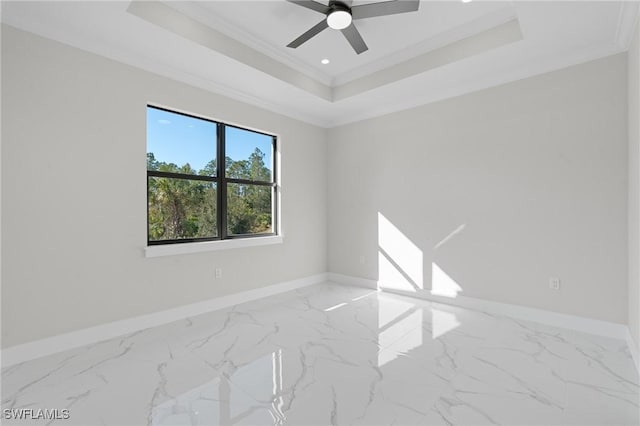 unfurnished room with ornamental molding, ceiling fan, and a tray ceiling