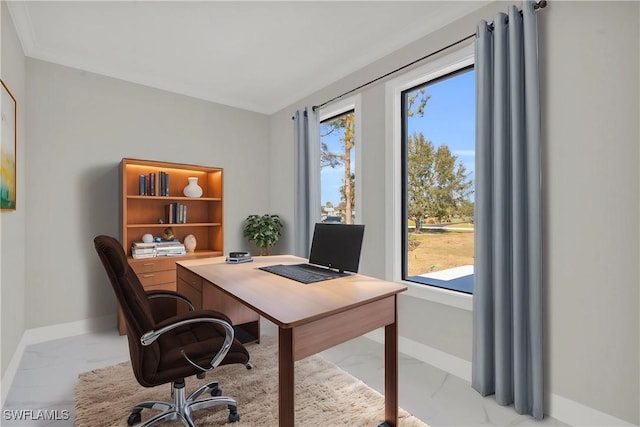 office area with marble finish floor, a healthy amount of sunlight, and baseboards