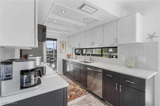 kitchen featuring beam ceiling, white cabinetry, dishwasher, sink, and decorative backsplash