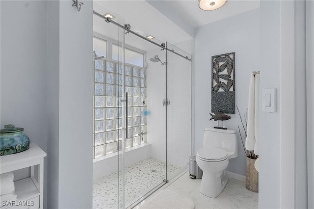 bathroom featuring toilet and an enclosed shower