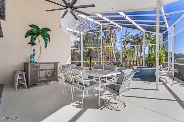 view of patio / terrace featuring glass enclosure and an in ground hot tub