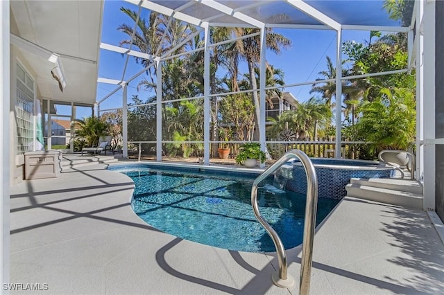 view of pool featuring an in ground hot tub, a lanai, and a patio area