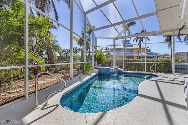 view of swimming pool featuring an in ground hot tub, a patio, and a lanai