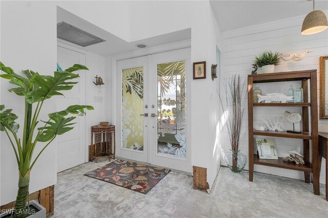 doorway featuring wooden walls and french doors