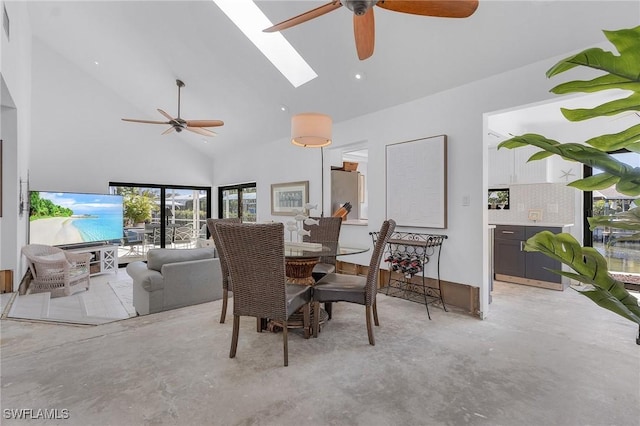 dining room with a skylight, high vaulted ceiling, and ceiling fan