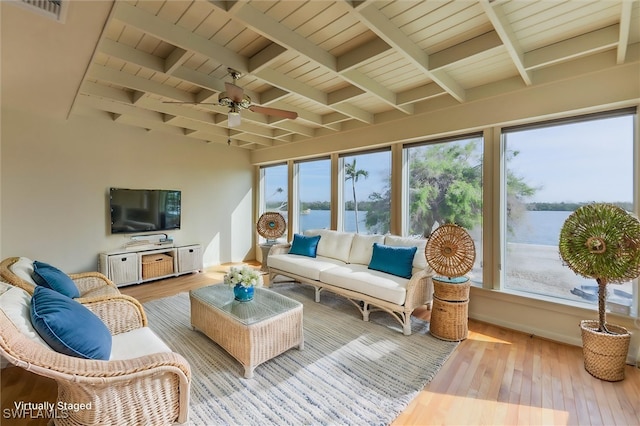 sunroom / solarium featuring beam ceiling, a water view, ceiling fan, and wood ceiling