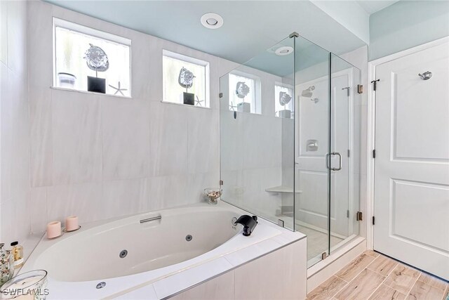 bathroom featuring separate shower and tub