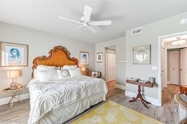 bedroom with light hardwood / wood-style flooring and ceiling fan