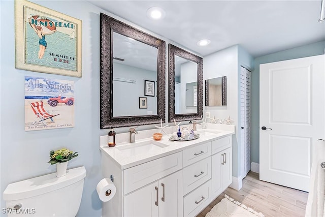788 Willowbrook Dr Unit 502, Naples, FL 34108 - full bathroom featuring toilet, double vanity, wood finished floors, and recessed lighting