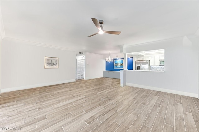 unfurnished living room featuring ceiling fan with notable chandelier, ornamental molding, and light hardwood / wood-style floors