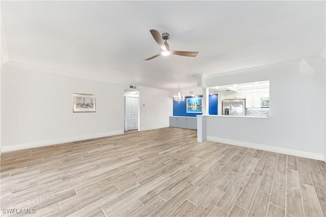 788 Willowbrook Dr Unit 502, Naples, FL 34108 - unfurnished living room featuring a chandelier, light wood-style floors, ceiling fan, baseboards, and ornamental molding