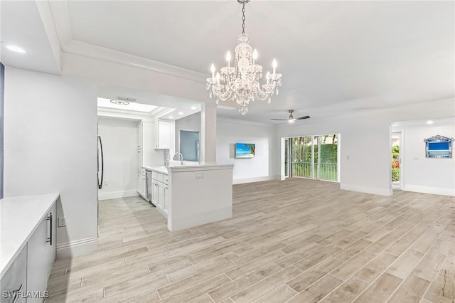 kitchen featuring open floor plan, light countertops, crown molding, and light wood-style floors