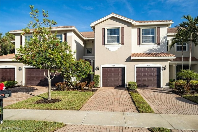 6502 Monterey Pt Unit 202, Naples, FL 34105 - multi unit property with a tile roof, stucco siding, a garage, and driveway