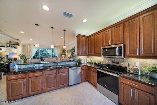 6502 Monterey Pt Unit 202, Naples, FL 34105 - kitchen with stainless steel appliances, ornamental molding, a peninsula, backsplash, and dark stone counters