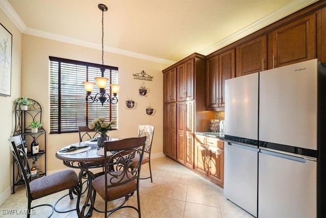 6502 Monterey Pt Unit 202, Naples, FL 34105 - kitchen with freestanding refrigerator, a chandelier, ornamental molding, hanging light fixtures, and light tile patterned flooring