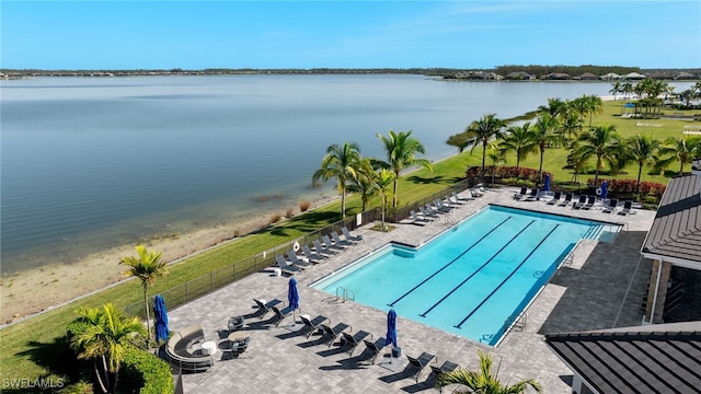 view of swimming pool with a water view and a patio