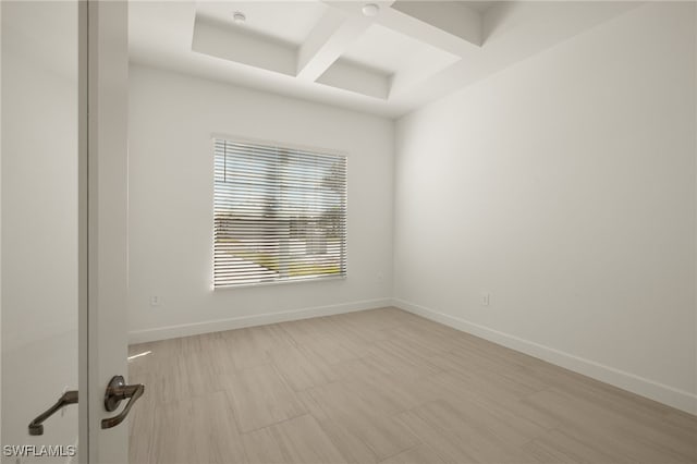 unfurnished room featuring beam ceiling and coffered ceiling