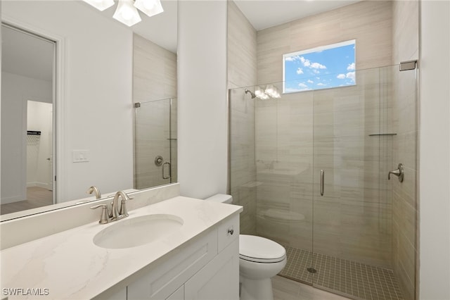 bathroom featuring an enclosed shower, vanity, toilet, and tile patterned flooring