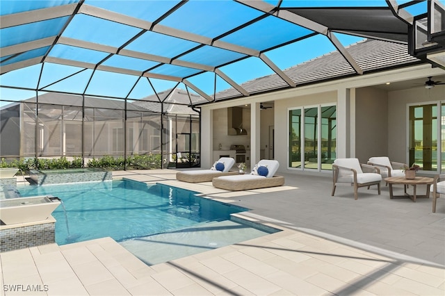 view of pool with ceiling fan, a lanai, and a patio