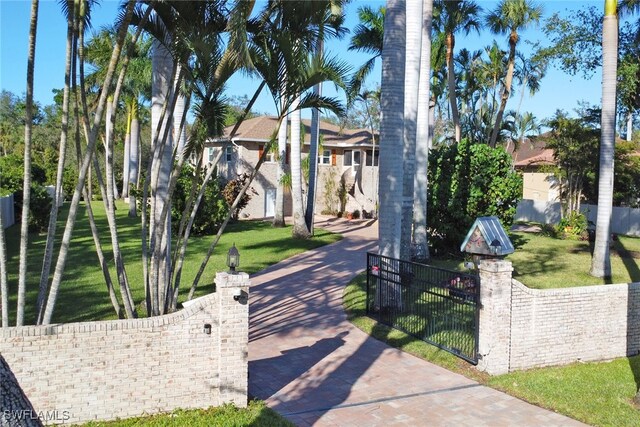 view of front of property featuring a fenced front yard, a front yard, and a gate