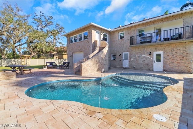 view of swimming pool featuring fence, a fenced in pool, and a patio