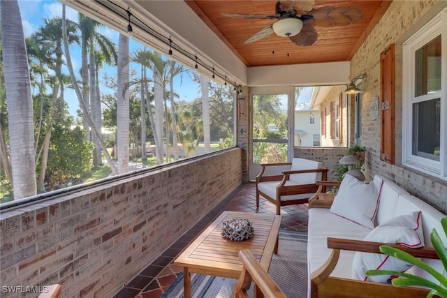 unfurnished sunroom with wooden ceiling and a ceiling fan