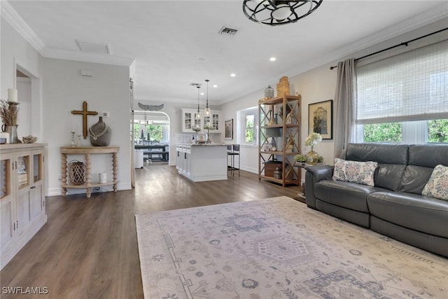 unfurnished living room featuring crown molding, visible vents, dark wood-type flooring, and recessed lighting