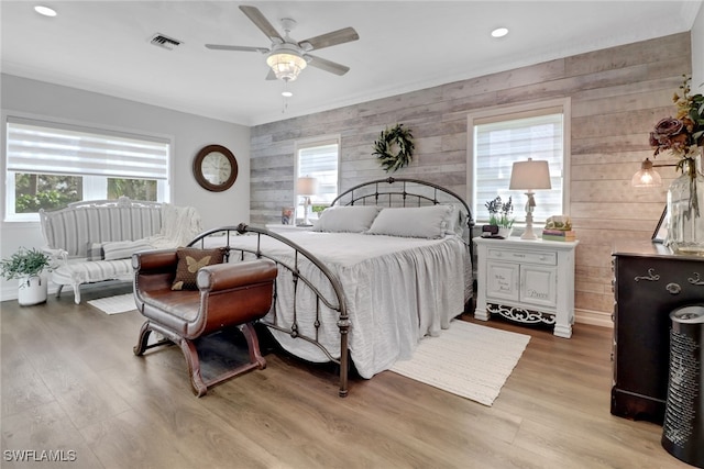 bedroom with a ceiling fan, wood finished floors, visible vents, and recessed lighting