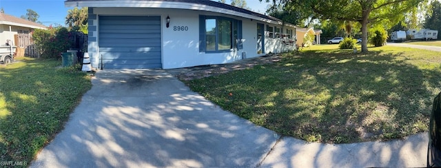 exterior space featuring a garage and a front yard