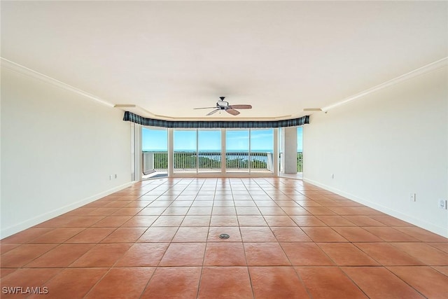 unfurnished room featuring light tile patterned flooring, expansive windows, ornamental molding, and ceiling fan