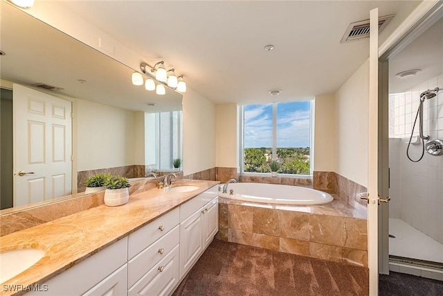 bathroom featuring vanity and shower with separate bathtub