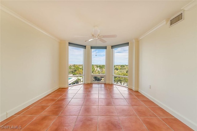 tiled empty room with floor to ceiling windows, crown molding, and ceiling fan