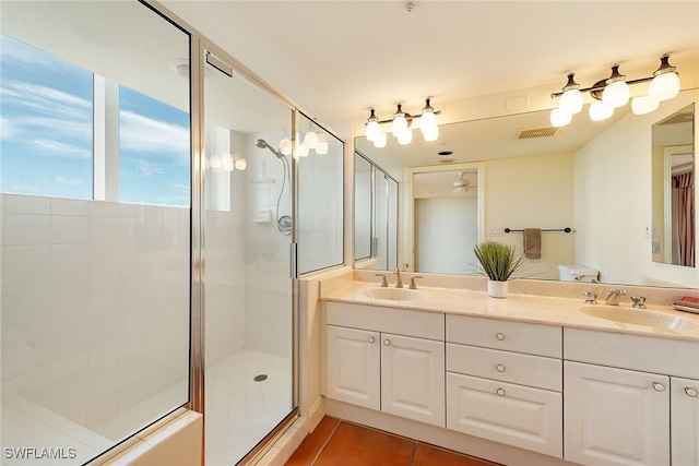 bathroom with tile patterned flooring, vanity, ceiling fan, and a shower with door